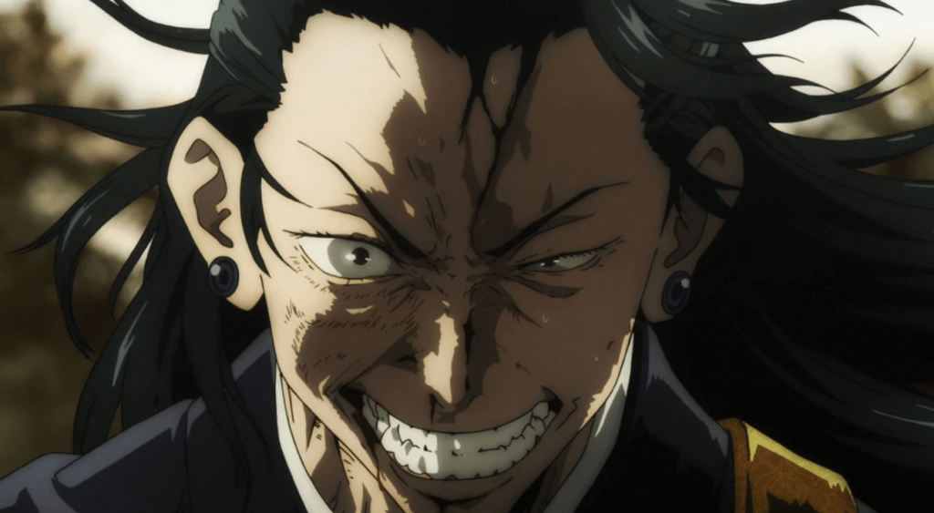 An angry man with an injured face stares forward through clenched teeth, his long black hair flowing in the wind.